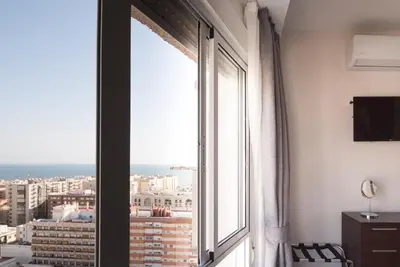 a window in a room with a view of a city at Apartment Altavista in Cádiz