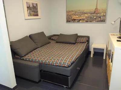 a small bed in a room with a small table at Apartamento Cantabrico in Cádiz