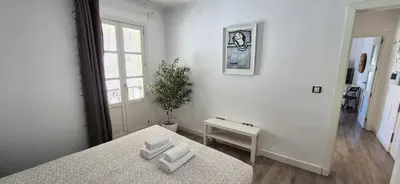 a bedroom with a bed and a table with towels at Sopranis by Gades Gestión in Cádiz