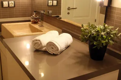 a bathroom with towels on a counter with a sink at Sopranis by Gades Gestión in Cádiz
