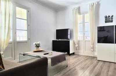 a living room with a couch and a tv at Sopranis by Gades Gestión in Cádiz