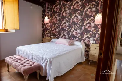 a bedroom with a bed with a floral wallpaper at Jerez Centro MRZ Rentals in Jerez de la Frontera