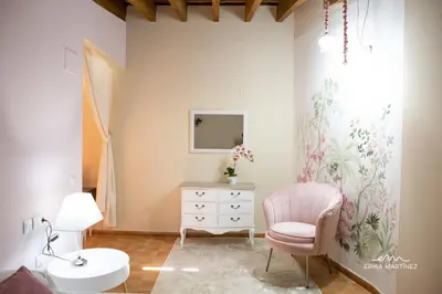 a bathroom with a pink chair and a dresser at Jerez Centro MRZ Rentals in Jerez de la Frontera