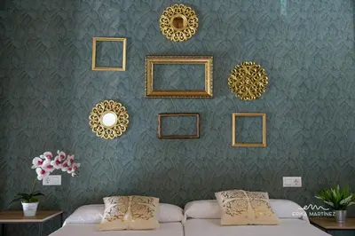a living room with a couch and a wall with mirrors at Jerez Centro MRZ Rentals in Jerez de la Frontera