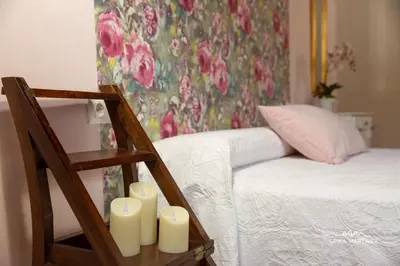 a group of candles on a table next to a bed at Jerez Centro MRZ Rentals in Jerez de la Frontera