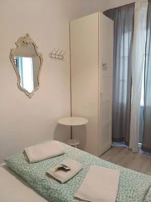 a bedroom with a bed with a mirror on the wall at Pensión Cádiz in Cádiz