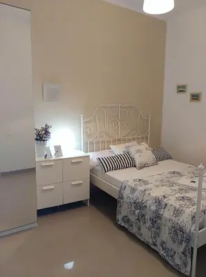 a bedroom with two beds and a white dresser and a bed sidx sidx sidx at Pensión Cádiz in Cádiz