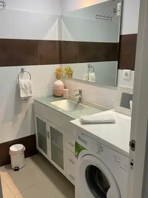 a bathroom with a washing machine and a sink at Pensión Cádiz in Cádiz