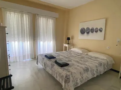 a bedroom with a large bed in a room at Apartamento Playa Muralla in El Puerto de Santa María