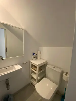 a bathroom with a toilet and a sink and a mirror at Apartamento Playa Muralla in El Puerto de Santa María