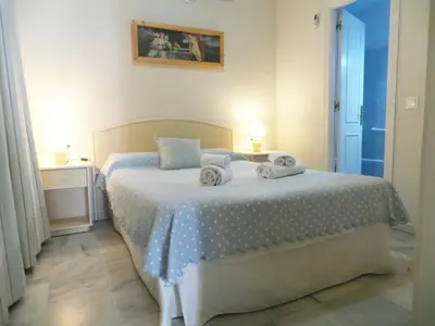 a room with chairs and a table and a window at Apartamentos Larga 70 in El Puerto de Santa María
