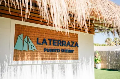 a sign on the side of a building with a water fountain at Hotel Puerto Sherry in El Puerto de Santa María
