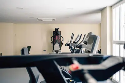 a gym with cardio equipment in a room at Hotel Puerto Sherry in El Puerto de Santa María
