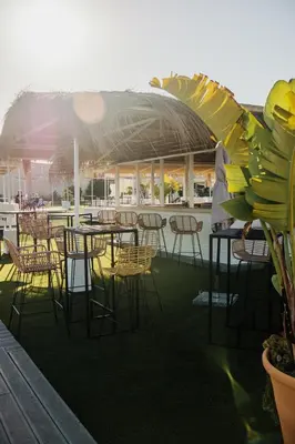 a group of tables and chairs on a patio at Hotel Puerto Sherry in El Puerto de Santa María