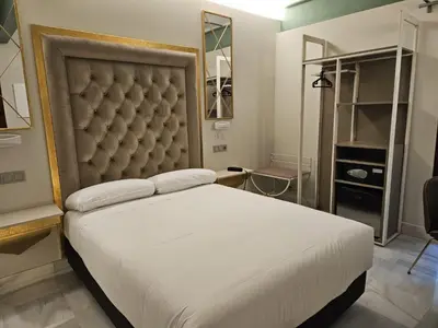 a bedroom with a large bed with a large headboard at Hotel YIT Casa Grande in Jerez de la Frontera