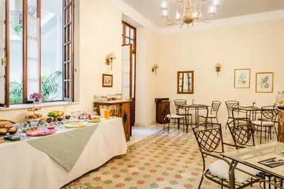 a dining room with tables and chairs and windows at Hotel YIT Casa Grande in Jerez de la Frontera
