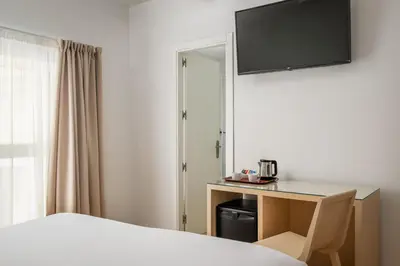 a hotel room with a bed and a desk at BYPILLOW Tiento in Cádiz