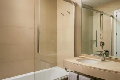 a bathroom with a sink and a shower at BYPILLOW Tiento in Cádiz