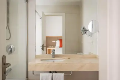 a bathroom with a sink and a mirror at BYPILLOW Tiento in Cádiz