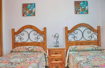 two beds sitting next to each other in a bedroom at Chalet Vigía 114 in Conil de la Frontera