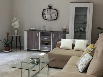 a living room with a couch and a glass table at Apartamento San Pedro in Cádiz