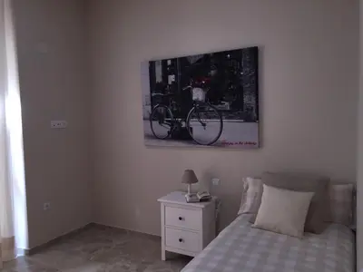 a bedroom with a bed and a picture of a bike on the wall at Apartamento San Pedro in Cádiz