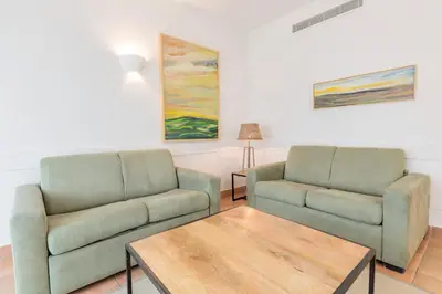 a living room with two couches and a coffee table at Aldiana Club Andalusien in Chiclana de la Frontera