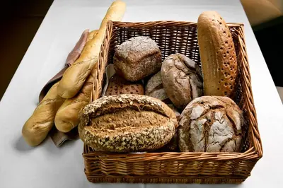 a basket filled with different types of bread on a table at Aldiana Club Andalusien in Chiclana de la Frontera