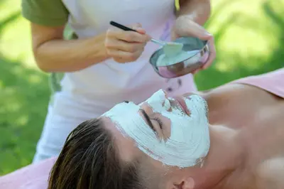 a man with a mask on his face getting a massage at Aldiana Club Andalusien in Chiclana de la Frontera