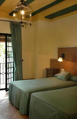 a bedroom with a large bed in a room at Mesón de la Molinera in Arcos de la Frontera