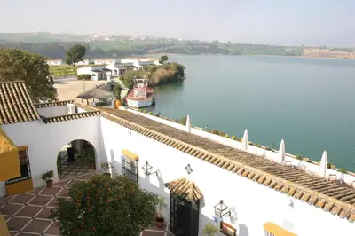 arial view of a river with a boat in the water at Mesón de la Molinera in Arcos de la Frontera