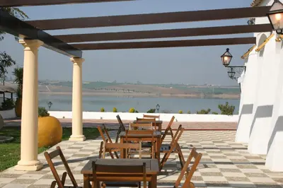 a row of tables and chairs on a patio at Mesón de la Molinera in Arcos de la Frontera