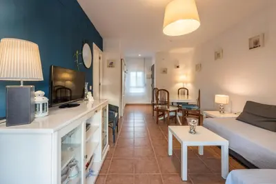 a living room with a couch and a table at Apartamento Mijares in Chiclana de la Frontera
