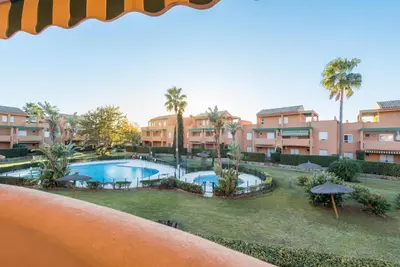 a view of the pool from the balcony of a resort at Apartamento Mijares in Chiclana de la Frontera