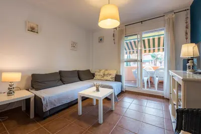 a living room with a couch and a table at Apartamento Mijares in Chiclana de la Frontera