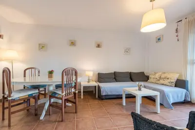 a living room with a couch and a table at Apartamento Mijares in Chiclana de la Frontera