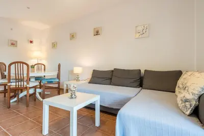 a living room with a couch and a table at Apartamento Mijares in Chiclana de la Frontera