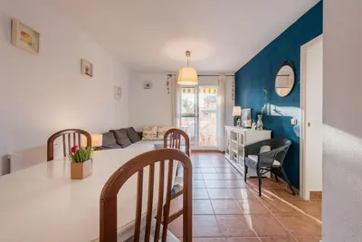 a kitchen and living room with a table and chairs at Apartamento Mijares in Chiclana de la Frontera