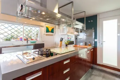 a kitchen with a stove and a counter top at artQhost Costa Ballena Penthouse Ocean and Golf views & Free Parking in Costa Ballena