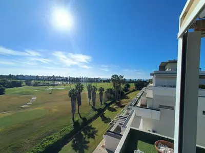 a view of the golf course from the balcony of a building at artQhost Costa Ballena Penthouse Ocean and Golf views & Free Parking in Costa Ballena