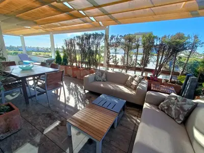 a living room with a couch and a table at artQhost Costa Ballena Penthouse Ocean and Golf views & Free Parking in Costa Ballena