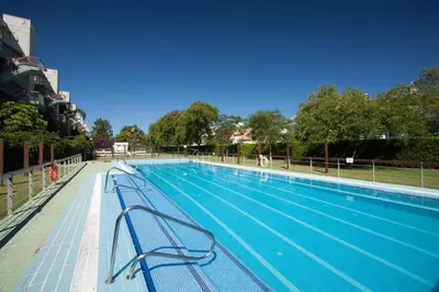 a large swimming pool with benches in a building at artQhost Costa Ballena Penthouse Ocean and Golf views & Free Parking in Costa Ballena