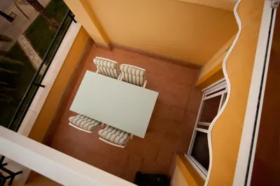 an overhead view of a bathroom with yellow walls and white towels at Ático Barrio de los Pescadores in Costa Ballena