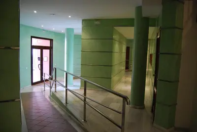 a hallway with green walls and stairs in a building at Atico Infanta Eulalia in Sanlúcar de Barrameda