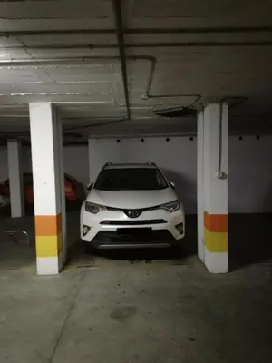 a white car parked in a parking garage at Atico Infanta Eulalia in Sanlúcar de Barrameda