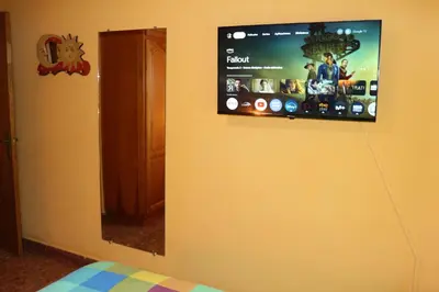 a flat screen tv on the wall of a bedroom at Apartamento La Venencia in Jerez de la Frontera