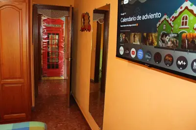 a hallway with a phone booth and a red door at Apartamento La Venencia in Jerez de la Frontera