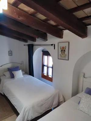a bedroom with two beds and a window at Casa Seven Jerez in Jerez de la Frontera
