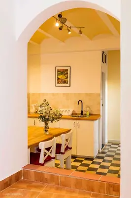 a kitchen with a table with a vase on it at Casa Seven Jerez in Jerez de la Frontera