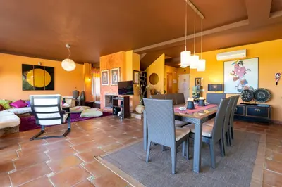 a dining room and living room with a table and chairs at Villa Golf Sanlucar in Sanlúcar de Barrameda
